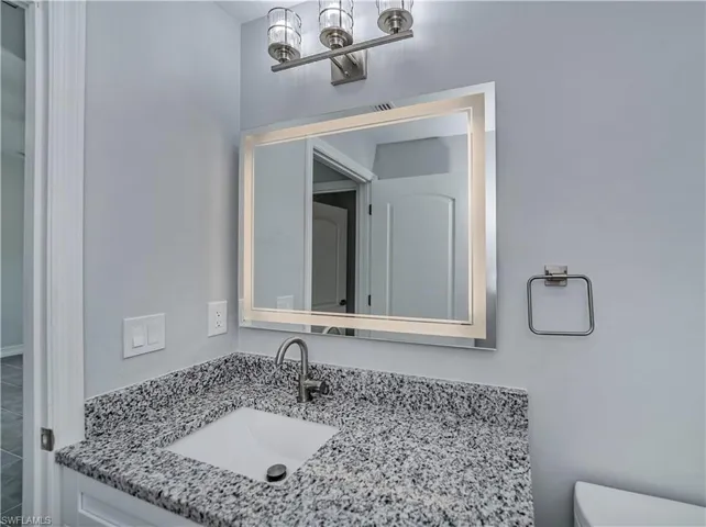 Bathroom featuring oversized vanity and toilet