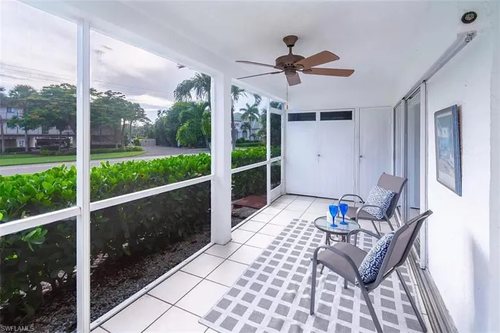 Unfurnished sunroom featuring ceiling fan