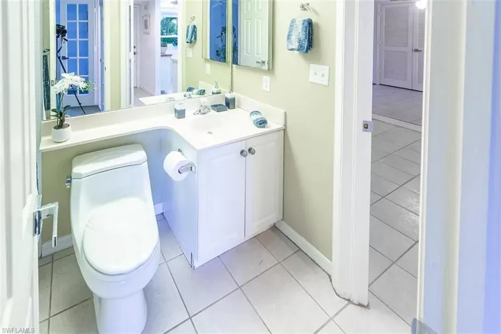 Bathroom with tile patterned floors, toilet, and vanity