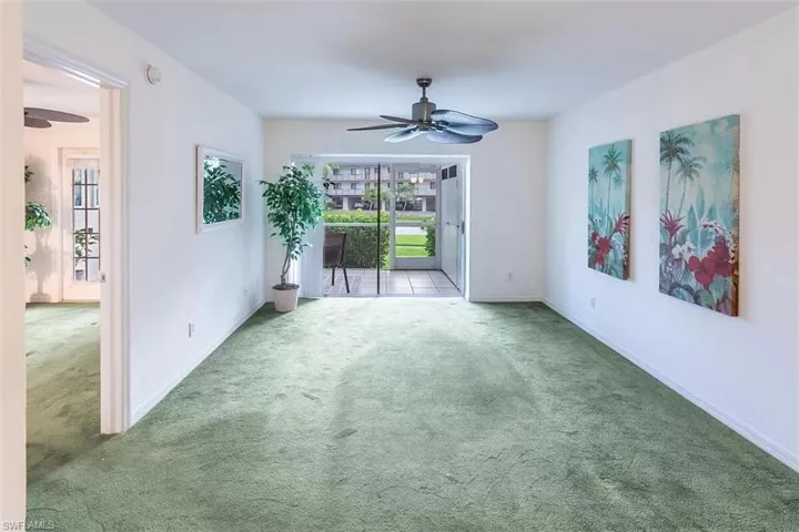 Carpeted spare room with ceiling fan