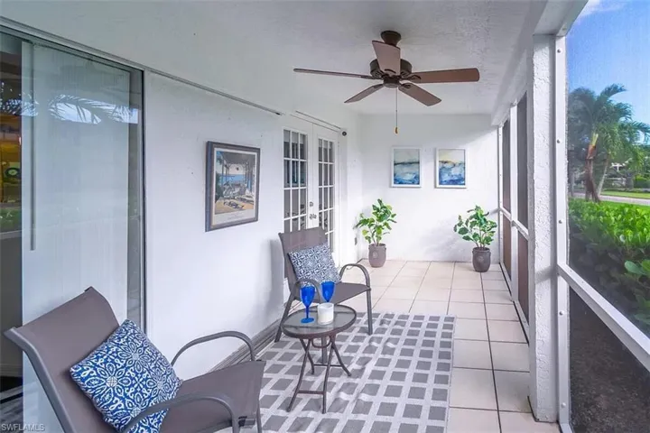 Sunroom / solarium featuring french doors and ceiling fan