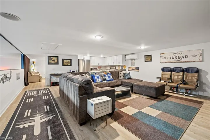 Living area featuring light wood-style flooring and a wall mounted mini split