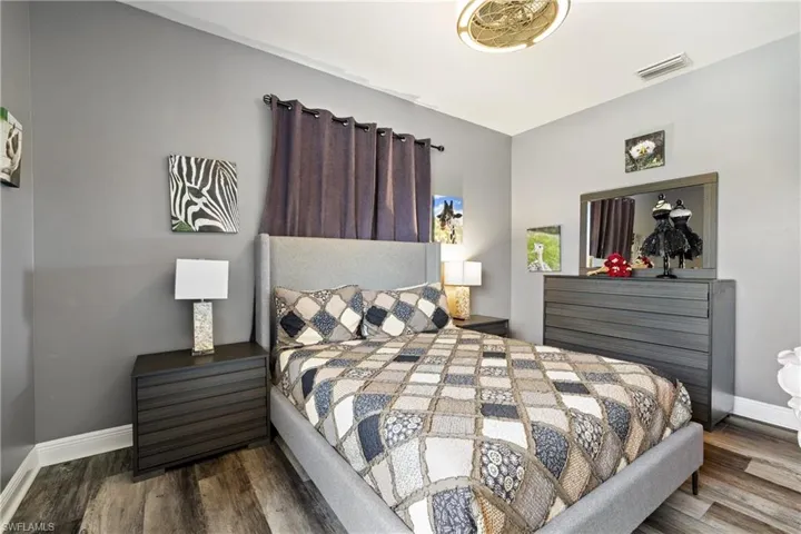 Bedroom featuring baseboards and dark wood finished floors
