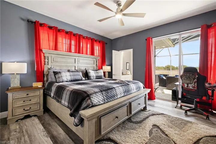 Bedroom featuring access to outside, light wood-style floors, and a ceiling fan