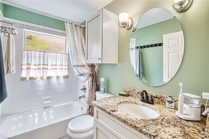 Full bath featuring vanity and shower / tub combo