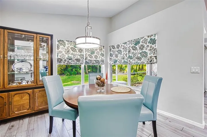 Dining space with light wood-type flooring and baseboards