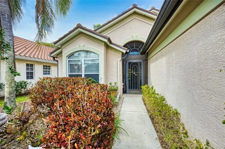 Property entrance featuring stucco siding