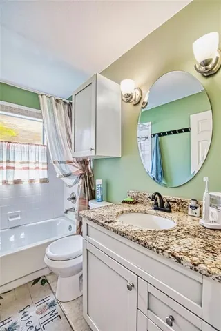 Full bathroom featuring vanity and shower / bath combination with curtain