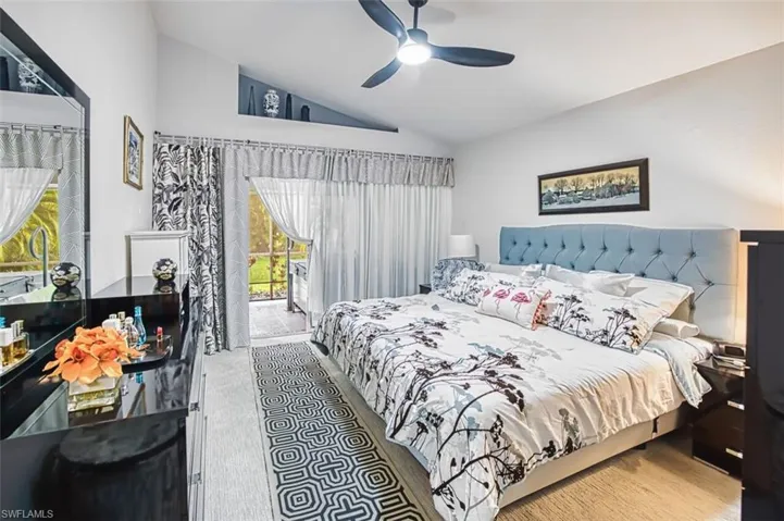 Bedroom featuring access to outside, vaulted ceiling, and ceiling fan