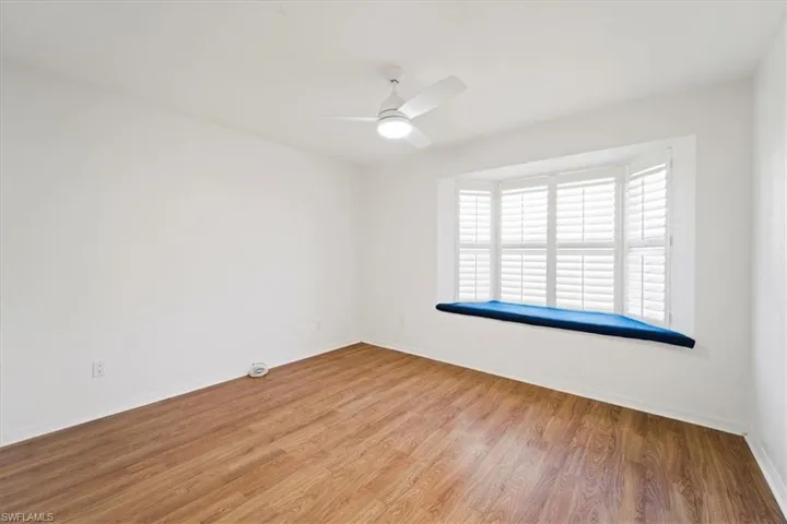 Unfurnished room featuring ceiling fan and light hardwood / wood-style flooring