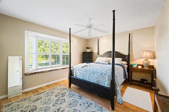 Bedroom featuring ceiling fan and wood-type flooring
