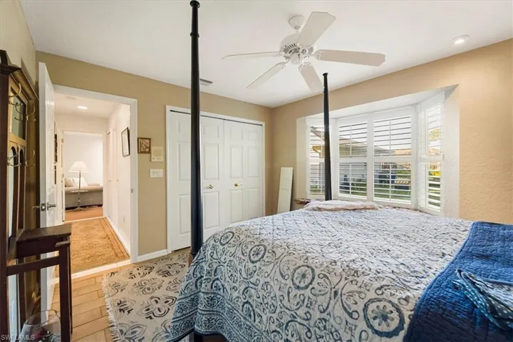 Bedroom with a closet, wood-type flooring, and ceiling fan