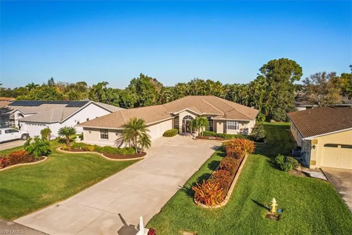 Ranch-style house featuring a garage and a front yard
