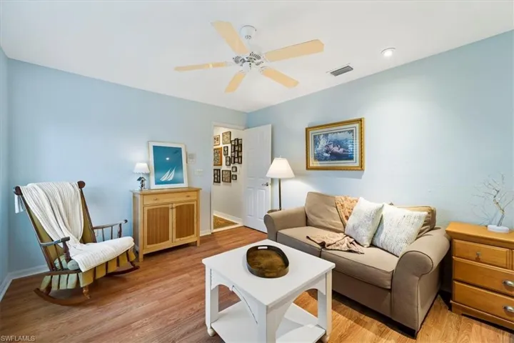 Living room featuring ceiling fan and light hardwood / wood-style flooring