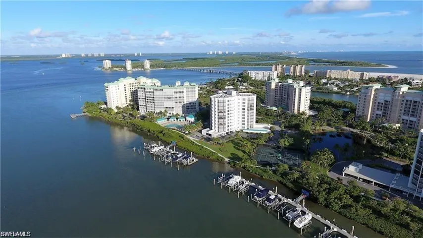 Aerial view highlighting the building’s prime waterfront setting and proximity to the beach.