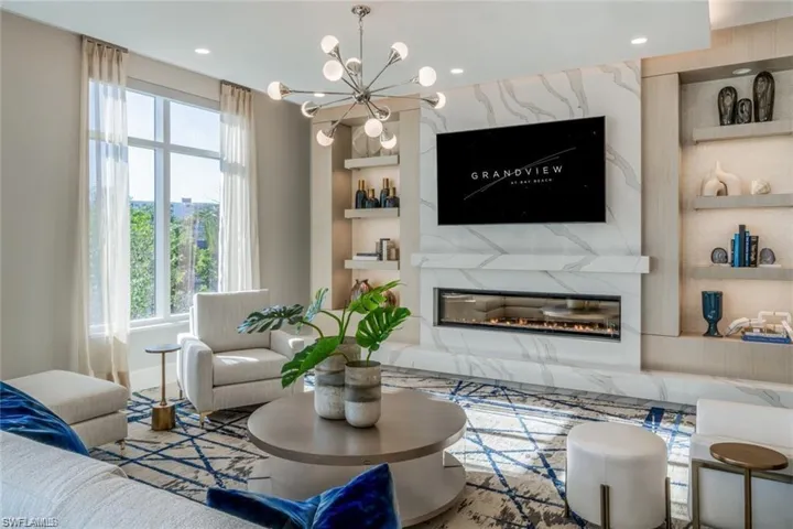 Located in the "EL" Stylish social room , with statement fireplace, built-in shelving, and spacious entertaining layout.
