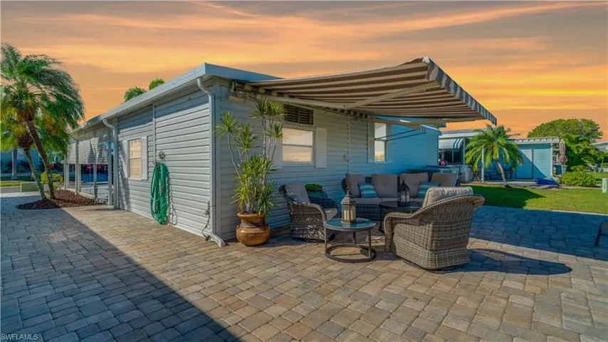 The 21' x 23' Back Patio is complete with quality outdoor furniture and a 14' Lighted Sunsetter Awning.