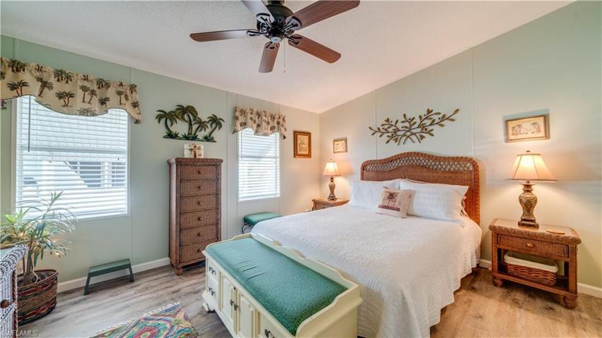 The master bedroom is complete with lovely furniture and furnishings. Yes; the LVT flooring continues...