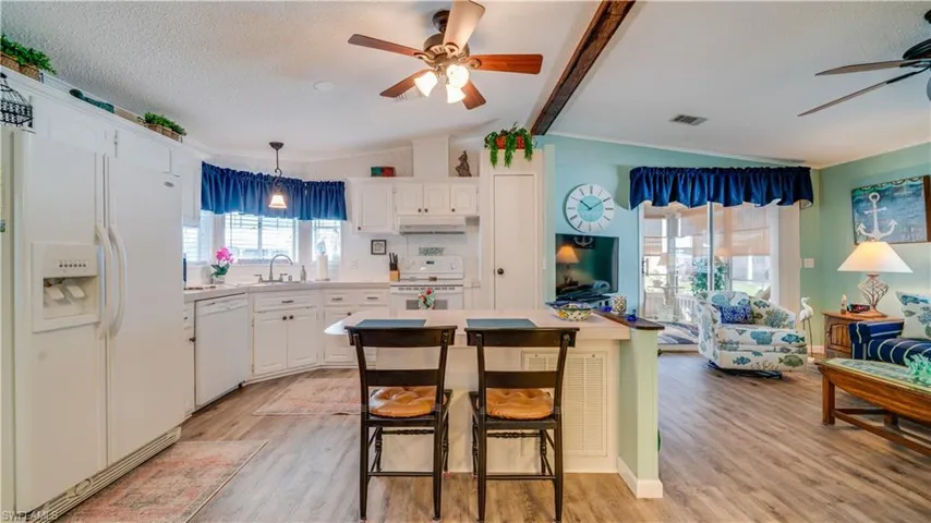 Notice the kitchen window. Notice the luxury vinyl tile flooring.