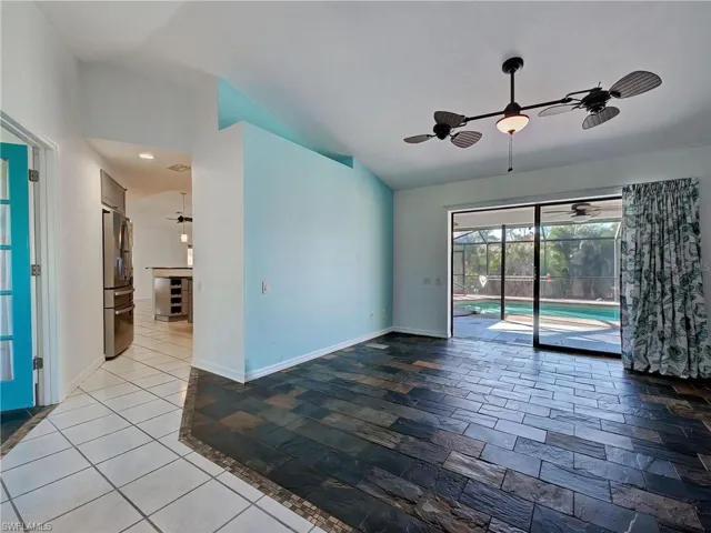 Spare room with a sunroom, ceiling fan, and lofted ceiling