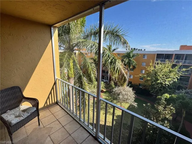 Balcony featuring a sunroom