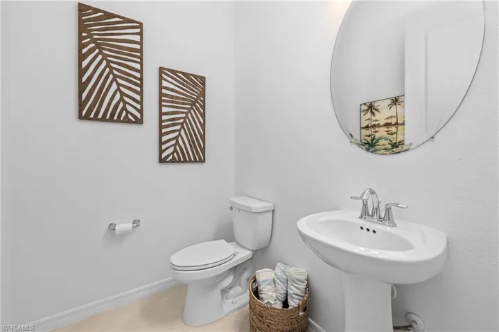 Half bathroom featuring toilet and tile patterned flooring