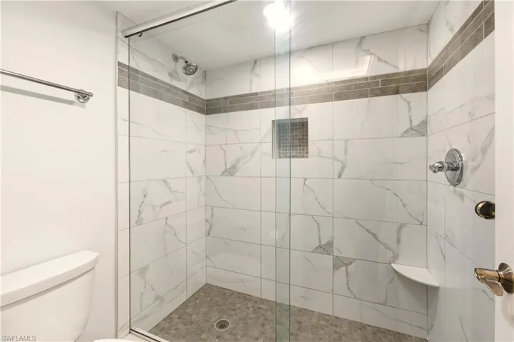 Full bath with a tile finish shower