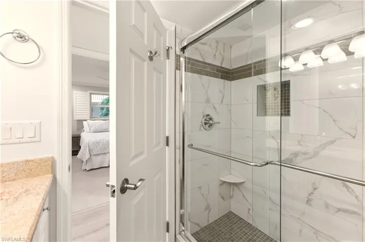 Bathroom with vanity, a tile finish shower.