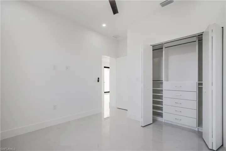 Unfurnished bedroom with visible vents, recessed lighting, a closet, baseboards, and concrete flooring
