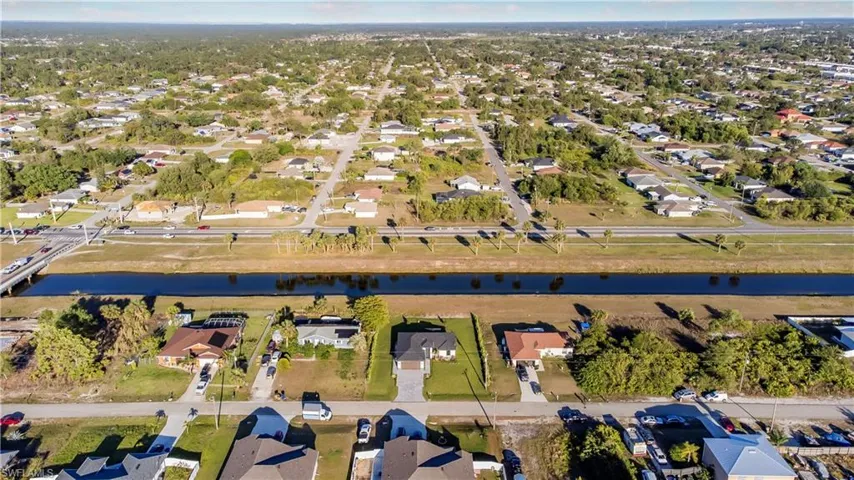 Birds eye view of property featuring a residential view and a water view