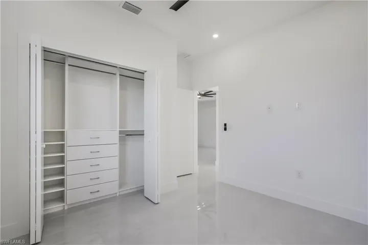 Unfurnished bedroom with recessed lighting, visible vents, baseboards, and a closet