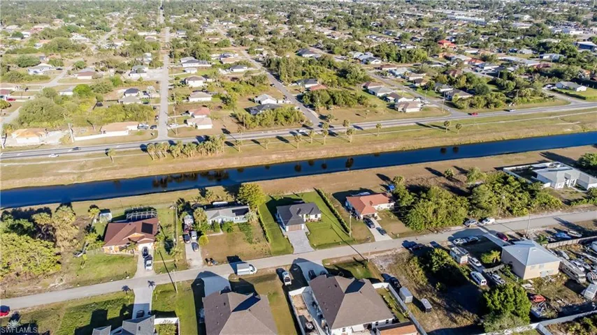 Aerial view featuring a residential view and a water view