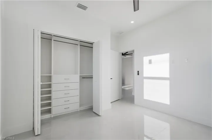 Unfurnished bedroom with a ceiling fan, visible vents, concrete floors, recessed lighting, and a closet