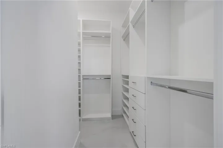 Walk in closet featuring marble finish floor