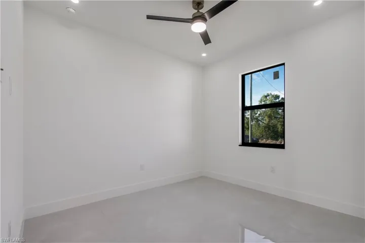 Spare room featuring recessed lighting, concrete flooring, baseboards, and ceiling fan