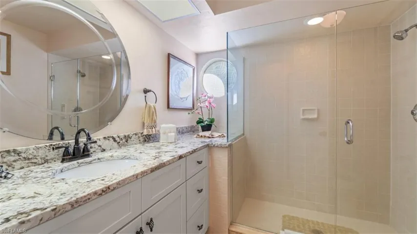 Full Guest bathroom with a stall shower and vanity