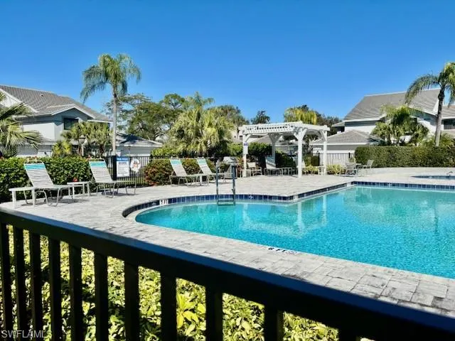 Community pool with a pergola and a patio