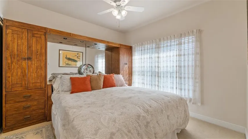 Guest Bedroom (1)with ceiling fan and light colored carpet
