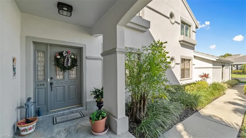 Entrance to property with stucco siding