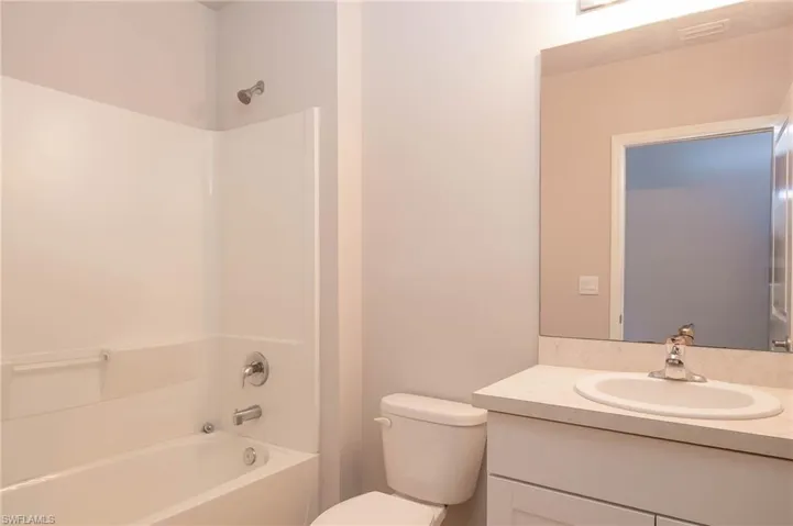 Full bath featuring vanity and washtub / shower combination