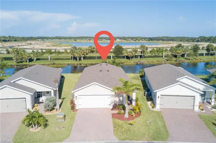 Aerial view of property and surrounding area featuring a large body of water