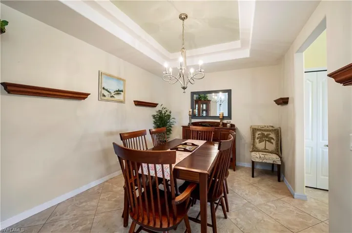Formal dining room with double tray ceilings.
