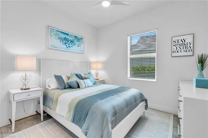 Bedroom with ceiling fan and light hardwood / wood-style floors