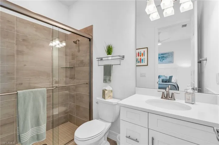 Bathroom with vanity, toilet, and walk in shower