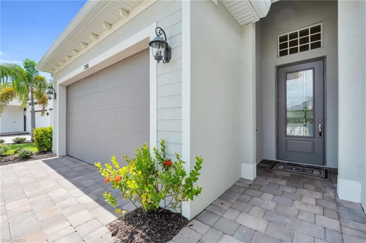 Doorway to property with a garage