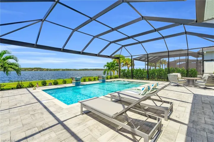 View of pool with a water view, a lanai, and a patio