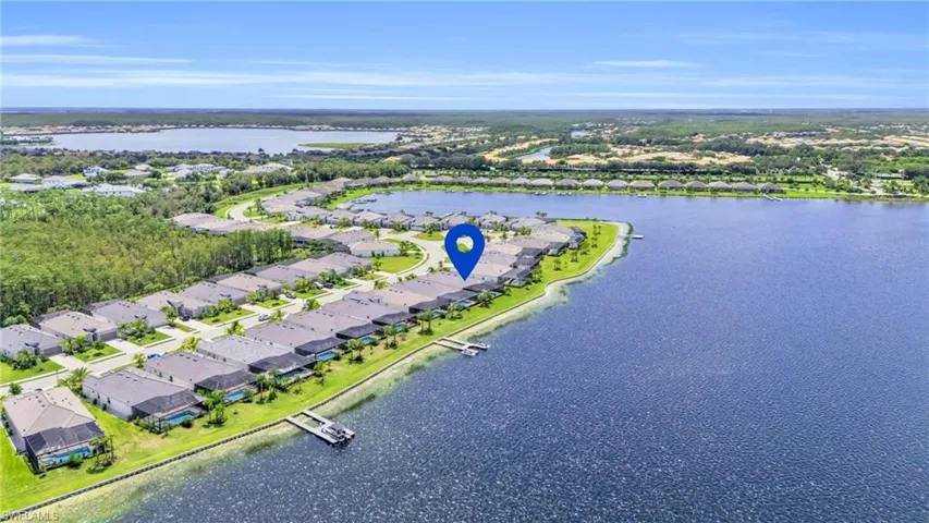 Birds eye view of property with a water view