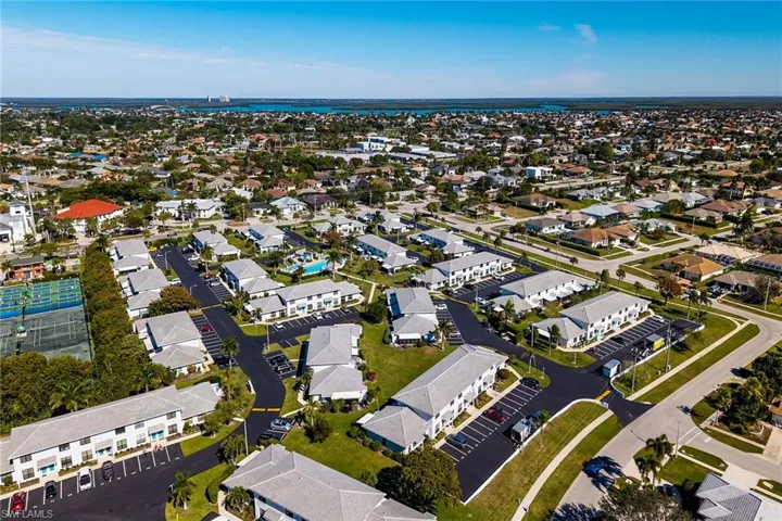 Aerial overview of property's location featuring nearby suburban area and a nearby body of water