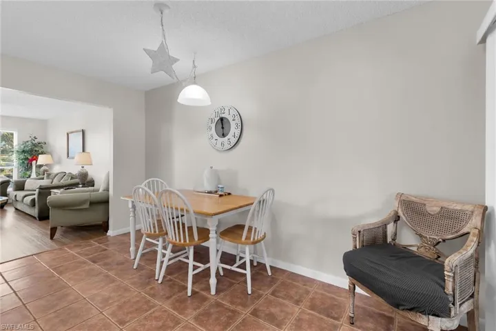 Dining area with tile patterned flooring and a textured ceiling
