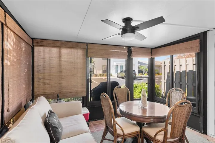 Sunroom with a ceiling fan and outdoor dining area